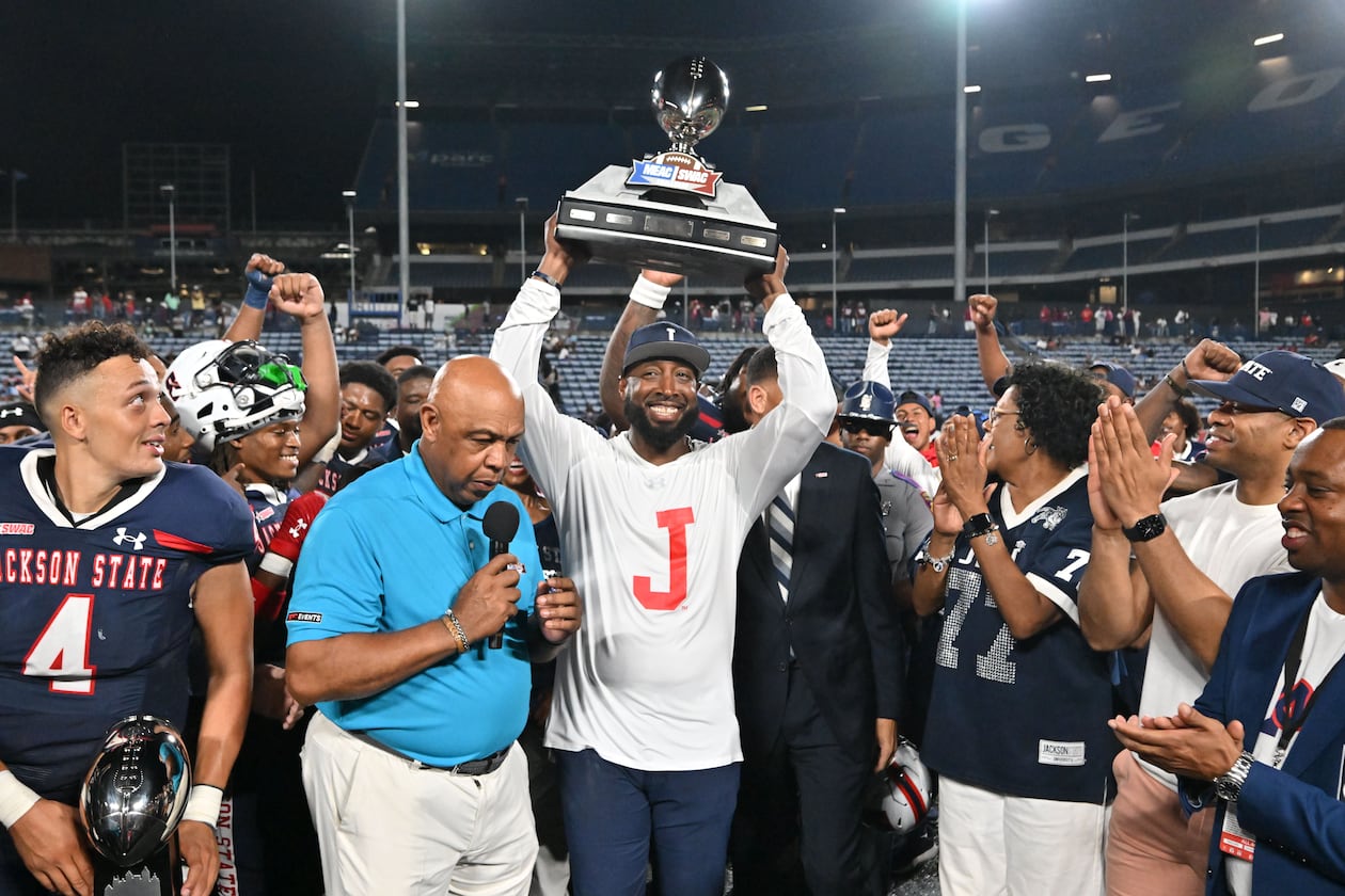 Jackson State's head coach T.C. Taylor holds up the trophy to celebrates their victory during the 2023 MEAC/SWAC Challenge at Center Parc Stadium, Saturday, August 26, 2023, in Atlanta. The 2026 MEAC/SWAC Challenge will feature Howard and Alabama A&M. (Hyosub Shin/AJC)