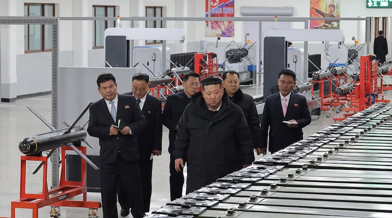 In this photo provided by the North Korean government, its leader Kim Jong Un, front right, visits a major munitions factory at an undisclosed place in North Korea Saturday, Jan. 3, 2026. Independent journalists were not given access to cover the event depicted in this image distributed by the North Korean government. The content of this image is as provided and cannot be independently verified. (Korean Central News Agency/Korea News Service via AP)