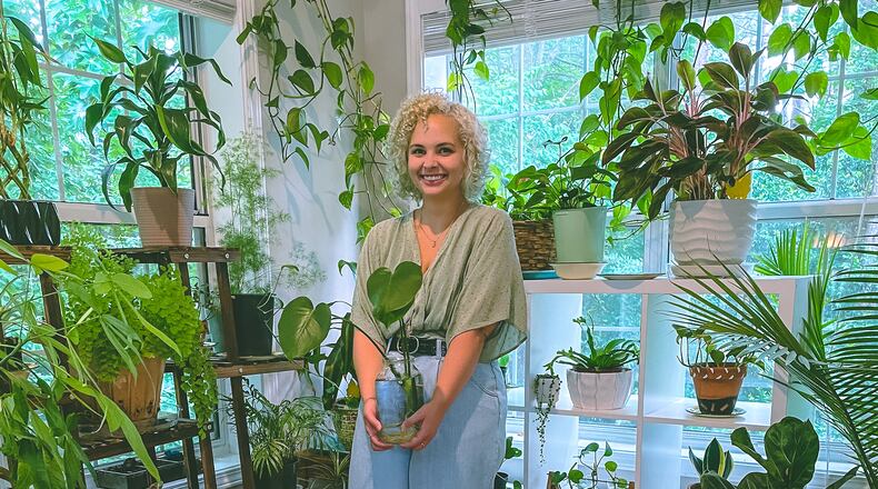 Mary Sanders poses with some of her 40-plus plants. 
Photo courtesy of Mary Sanders.