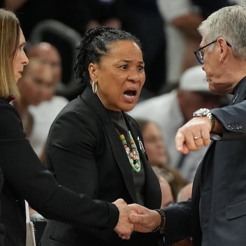 South Carolina head coach Dawn Staley, center, and UConn head coach Geno Auriemma argue after a woman's NCAA college basketball tournament semifinal game at the Final Four, Friday, April 3, 2026, in Phoenix. (AP Photo/Rick Scuteri)