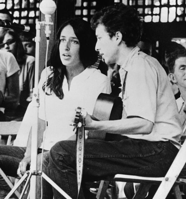 FILE - In this 1963 file photo, Joan Baez and Bob Dylan perform at the Newport Jazz Festival in Newport, R.I. Two years later, on the night of July 25, 1965, Dylan strode onto a stage at the Newport Folk Festival, plugged in an electric guitar and gave the music world a shock. Fifty years later, it's considered one of the most important events in rock history, the high-voltage moment when Dylan broke from folk and helped show his fellow musicians the poetic possibilities of rock. (AP Photo, File)