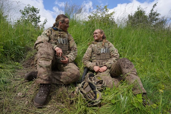 20-year-old conscript Katrine, right, speaks with another female conscript during final exercises at a training area close to Royal Danish Army’s barracks in Hovelte, 25 kilometres north of Copenhagen, Denmark, Wednesday, June 11, 2025. (AP Photo/James Brooks)