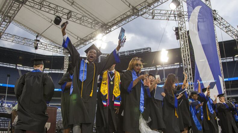 Georgia State University undergraduate students get on the stage at the 2018 commencement ceremony at Georgia State Stadium in Atlanta on May 10, 2018. The university had 2,638 transfer students last fall, more than any other University System of Georgia institution. Kennesaw State University was a close second, with 2,347 transfer students. (REANN HUBER/REANN.HUBER@AJC.COM)