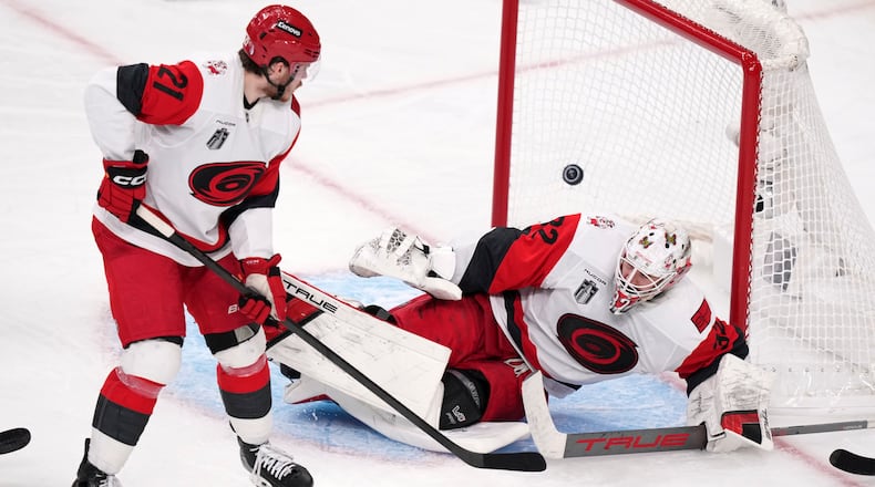 Carolina Hurricanes goaltender Brandon Bussi, right, is scored on by Carolina Hurricanes left wing Nikolaj Ehlers as defenseman Alexander Nikishin watches during the second overtime in Game 3 of the NHL hockey Stanley Cup Final series Saturday, June 6, 2026, in Las Vegas. (AP Photo/Candice Ward)