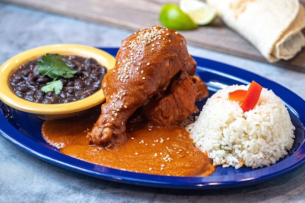 At 502 Antojitos, pepián is served with black beans, rice and a steaming pile of thick, handmade corn tortillas. (Courtesy of 502 Antojitos)