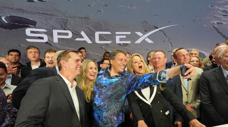 Gwynne Shotwell, President and COO of SpaceX, right, poses with colleagues during a bell ringing ceremony for the IPO of SpaceX at the Nasdaq MarketSite in New York, Friday, June 12, 2026, in New York. (AP Photo/Frank Franklin II)