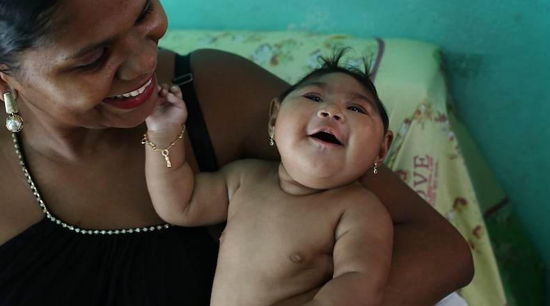 Maria da Luz Mendes Santos holds her daughter, Heloyse, who was born with microcephaly. Chinese researchers have pinpointed the single genetic change that has made the Zika virus a fearsome plague to pregnant women and their babies across the Americas, responsible for thousands of cases of microcephaly and other grievous brain abnormalities that sometimes result in death. (Katie Falkenberg/Los Angeles Times/TNS)