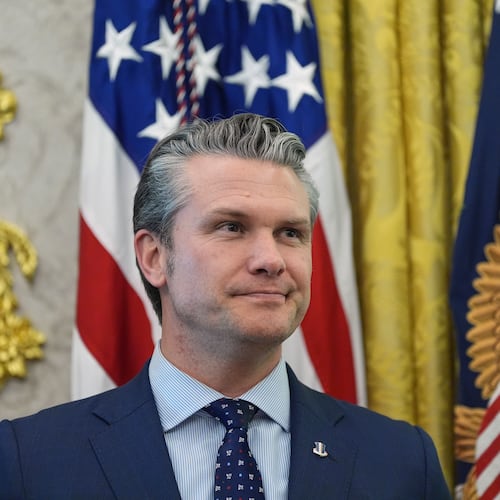 Defense Secretary Pete Hegseth listens as President Donald Trump speaks during the swearing in for Homeland Security Secretary Markwayne Mullin in the Oval Office of the White House, Tuesday, March 24, 2026, in Washington. (AP Photo/Alex Brandon)