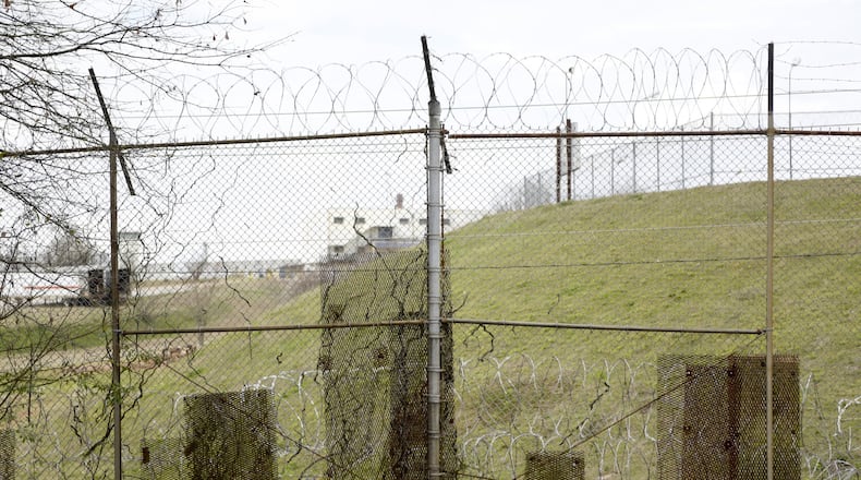 February 21, 2017, Atlanta - Patches of metal are bolted to the fence along the United States Penitentiary, Atlanta to cover holes in Atlanta, Georgia, on Tuesday, February 21, 2017. Minimum security inmates have used the holes in the fence to smuggle contraband back into the camps for years. (DAVID BARNES / SPECIAL)