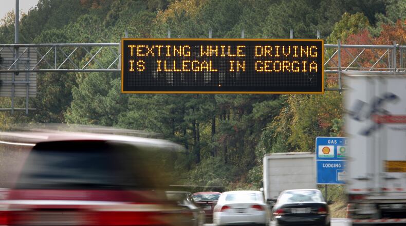 October 25, 2012 - Atlanta, Ga: A highway warning sign on I-285 westbound alert motorists that, "Texting while driving is illegal in Georgia, " before exit 22 near I-75 on the north side of Atlanta Thursday afternoon in Atlanta, Ga., October 25, 2012. Georgia's law outlawing texting while driving has proven diffficult to enforce. Police are writing fewer tickets than expected, raking in far less revenue than supporters of the measure had hoped. JASON GETZ / JGETZ@AJC.COM