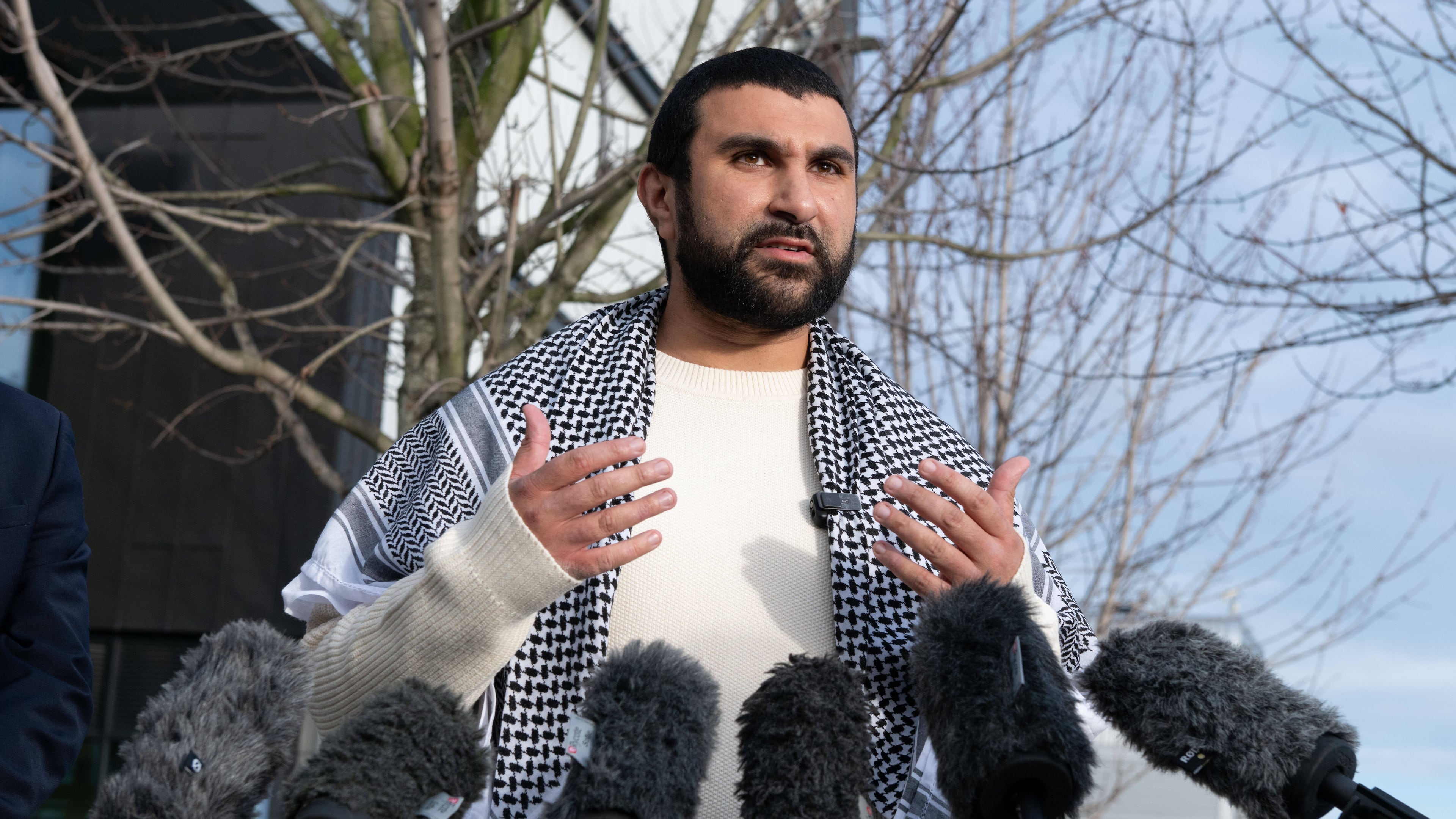British political commentator Sami Hamdi speaks to the media in London, Thursday, Nov. 13, 2025, on his return to the U.K. after he was arrested by Immigration and Customs Enforcement on Oct. 26 while on a speaking tour in the U.S.. (AP Photo/Thomas Krych)