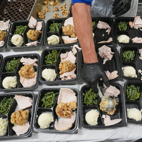 A volunteer prepares meals at the Philabundance Community Kitchen in Philadelphia, Thursday, Oct. 30, 2025. (AP Photo/Matt Rourke)