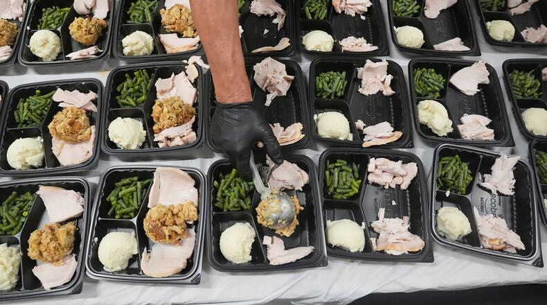 A volunteer prepares meals at the Philabundance Community Kitchen in Philadelphia, Thursday, Oct. 30, 2025. (AP Photo/Matt Rourke)