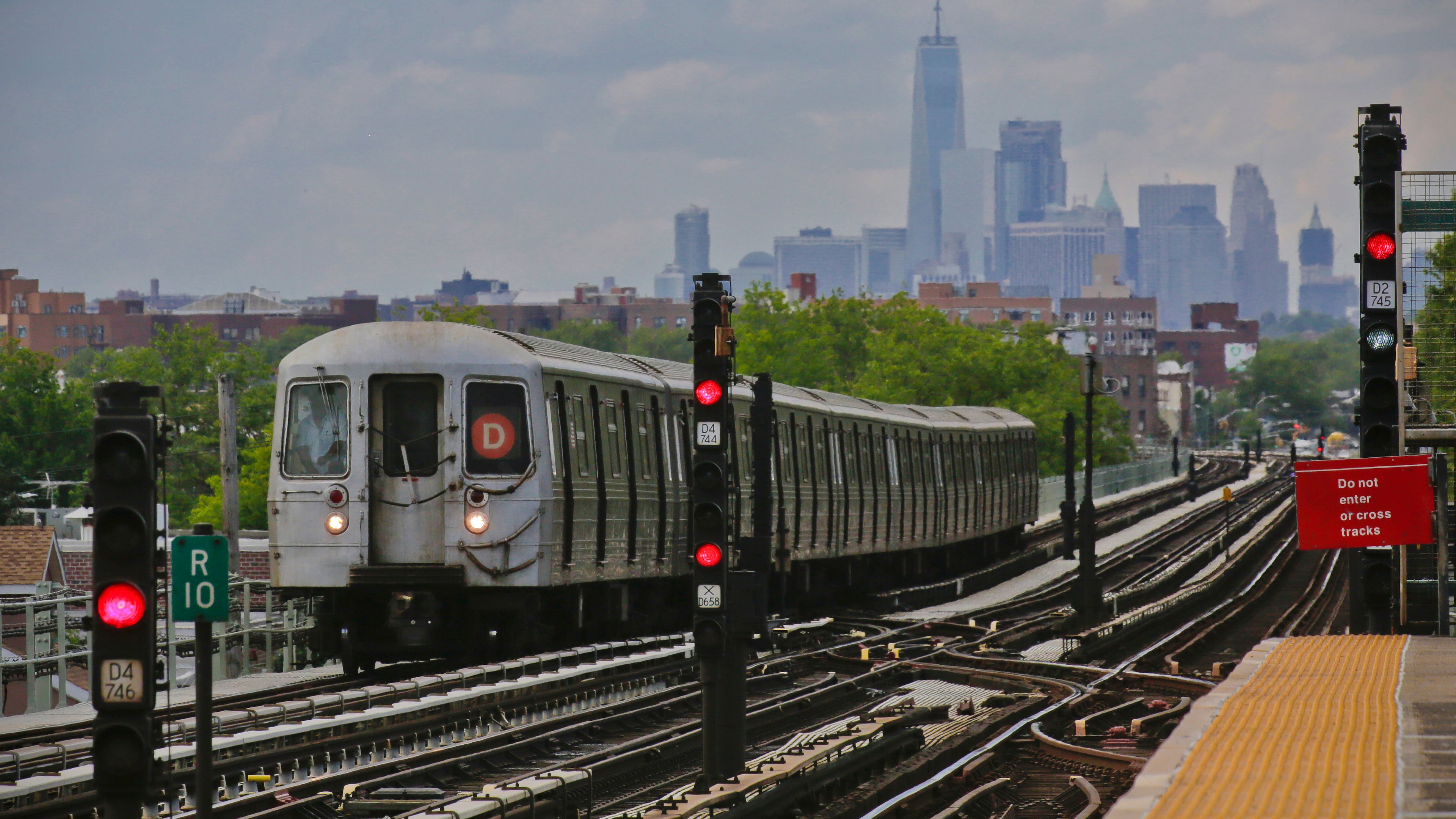 FILE - A subway approaches an above ground station in the Brooklyn borough of New York with the New York City skyline in the background, June 21, 2017. (AP Photo/Bebeto Matthews, File)