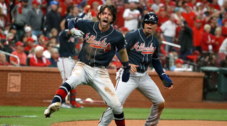 Braves Dansby Swansonand (left) and Rafael Ortega celebrate scoring the go-ahead runs against the St. Louis Cardinals during the ninth inning of Game 3 of the Division Series Oct. 6, 2019, at Busch Stadium in St. Louis.