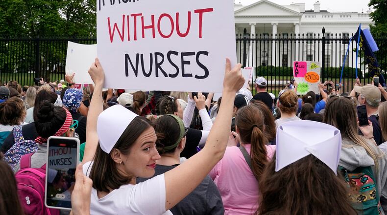 FILE - People protest outside the White House in Washington, May 12, 2022. (AP Photo/Susan Walsh)