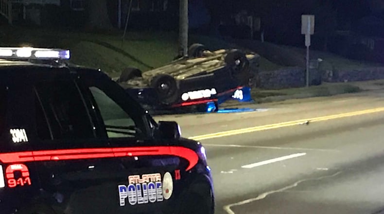 An Atlanta police officer was not seriously hurt when he crashed his patrol car and it flipped over, police said.