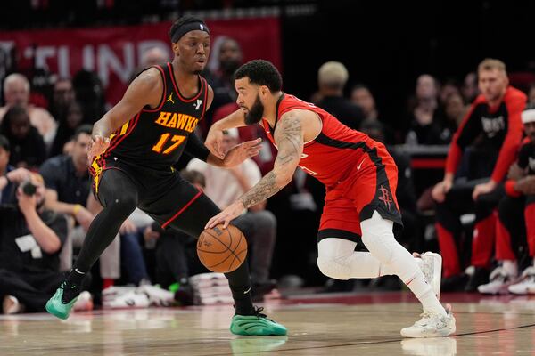 Houston Rockets' Fred VanVleet, right, drives toward the basket as Atlanta Hawks' Onyeka Okongwu (17) defends during the first half of an NBA basketball game Tuesday, March 25, 2025, in Houston. (AP Photo/David J. Phillip)