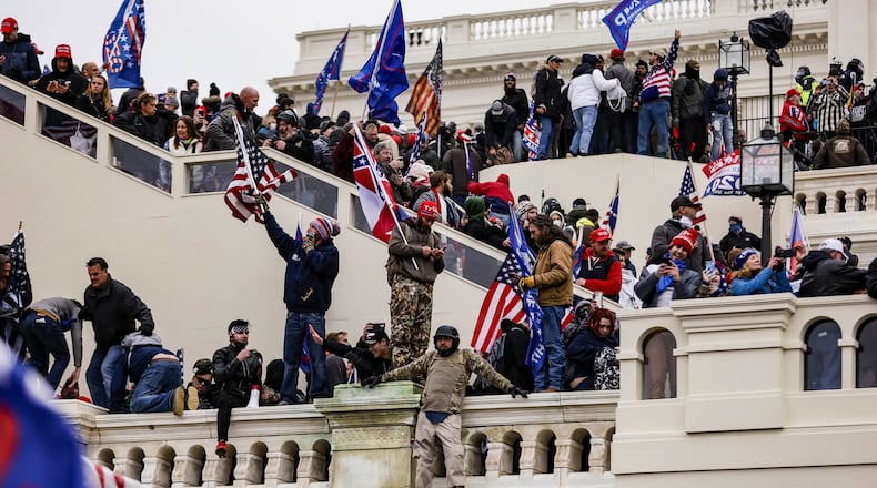 Pro-Trump supporters storm the U.S. Capitol following a rally with President Donald Trump on Wednesday in Washington. A spokeswoman for U.S. Rep. Jody Hice, R-Greensboro, said Thursday morning that after the protest turned violent, the congressman removed a post from Instagram saying "This is our 1776 moment" because he did not intend it "to be misinterpreted as a consent of the insurrection." (Samuel Corum/Getty Images/TNS)