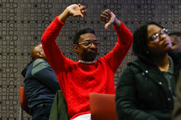 Nathaniel Dyer puts his thumbs down during an Atlanta School Board meeting in Atlanta on Wednesday, Dec. 3, 2025. APS held its final vote on school consolidation plans, approving several school closures. (Abbey Cutrer/AJC)