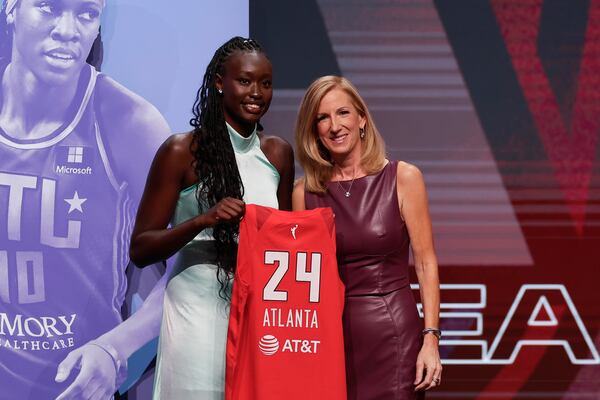 Australia's Nyadiew Puoch, left, poses for a photo with WNBA commissioner Cathy Engelbert after being selected 12th overall by the Atlanta Dream during the first round of the WNBA basketball draft on Monday, April 15, 2024, in New York. (AP Photo/Adam Hunger)