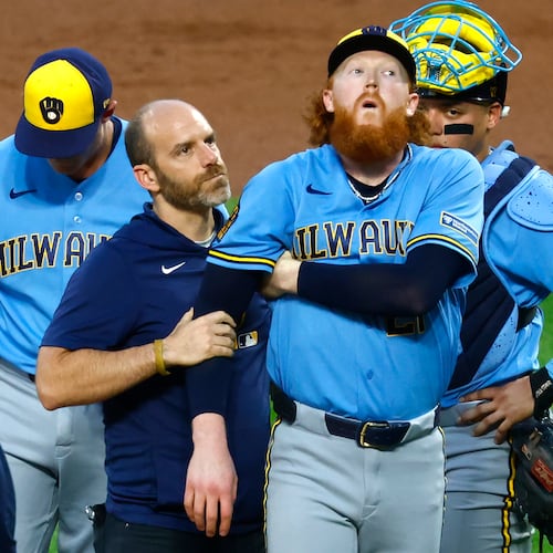 Milwaukee Brewers pitcher Dustin May reacts after being hit by a batted ball during the first inning of a baseball game against the New York Mets, Wednesday, Aug. 26, 2026, in New York. (AP Photo/Noah K. Murray)