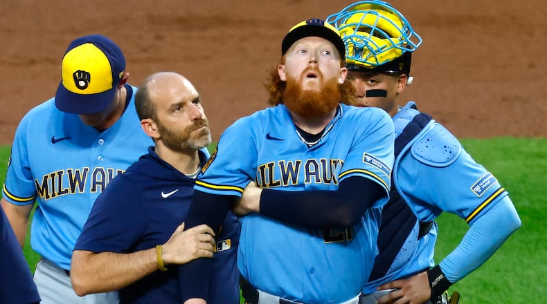 Milwaukee Brewers pitcher Dustin May reacts after being hit by a batted ball during the first inning of a baseball game against the New York Mets, Wednesday, Aug. 26, 2026, in New York. (AP Photo/Noah K. Murray)
