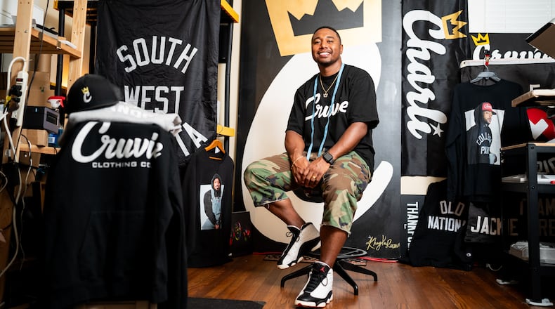 Tony Cruver, who founded Cruvie Clothing in 2013, poses at his home workspace in West End in Atlanta on Tuesday, July 16, 2024. (Seeger Gray / AJC)
