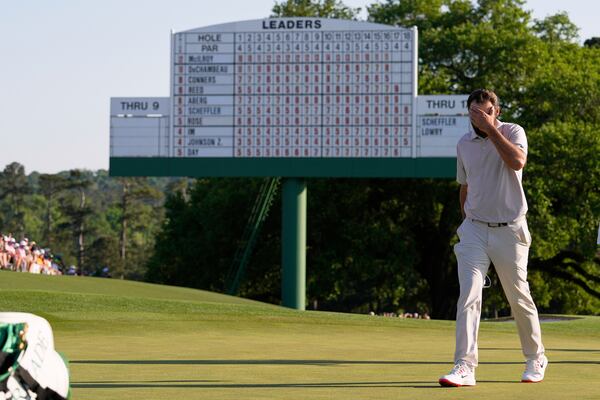 Scottie Scheffler walks off the green on the 18th hole during the final round at the Masters golf tournament, Sunday, April 13, 2025, in Augusta, Ga. (AP Photo/David J. Phillip)