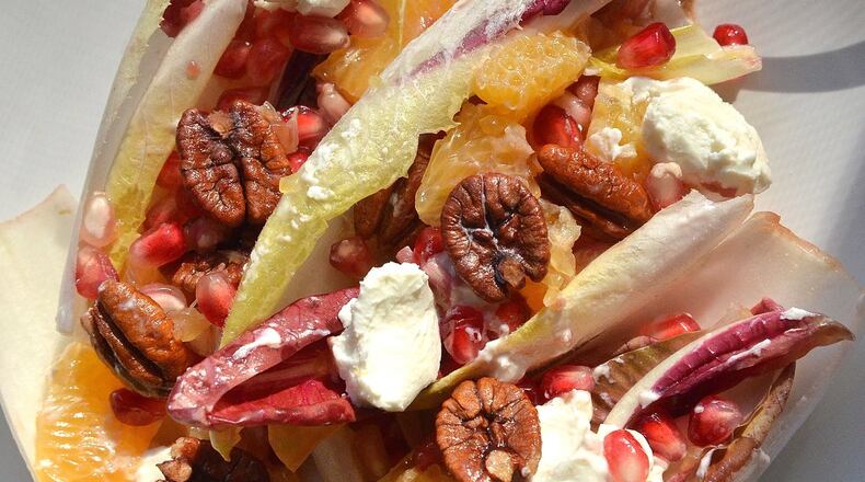 Gerry Klaskala, executive chef and owner of Aria in Buckhead, builds this Pomegranate, Mandarin and Endive Salad with Pecans and Fresh Goat Cheese from seasonal ingredients. (PHOTO BY CHRIS HUNT/SPECIAL. STYLING BY WENDELL BROCK)