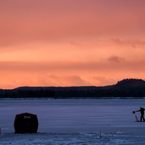 An ice fisherman starts his auger before drilling a hole in the ice on Long Lake following yesterday's freezing rainstorm, Tuesday, Dec. 30, 2025, in Harrison, Maine. (AP Photo/Robert F. Bukaty)