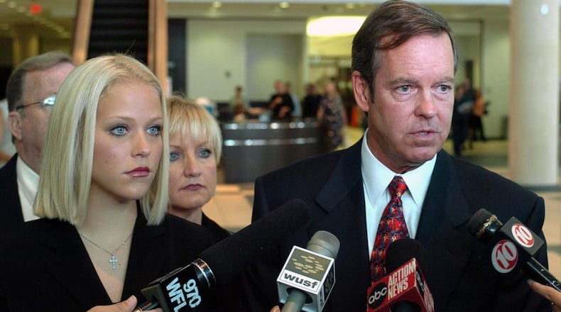 Former middle school teacher Debra Lafave, 24, left, stands with her attorney John Fitzgibbons, right, as he talks with reporters after a hearing  at the Hillsborough County Courthouse in Tampa, Fla., on July 18, 2005. Lafave, whose sexual liaisons with a 14-year-old student made tabloid headlines, broke off plea negotiations with prosecutors to claim insanity at her December trial.