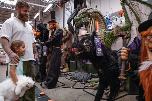 Igor Stepanov and his 4-year-old daughter, Luna, look at the Halloween display at Home Depot in Vinings on Monday, Sept. 29, 2025. (Natrice Miller/AJC)