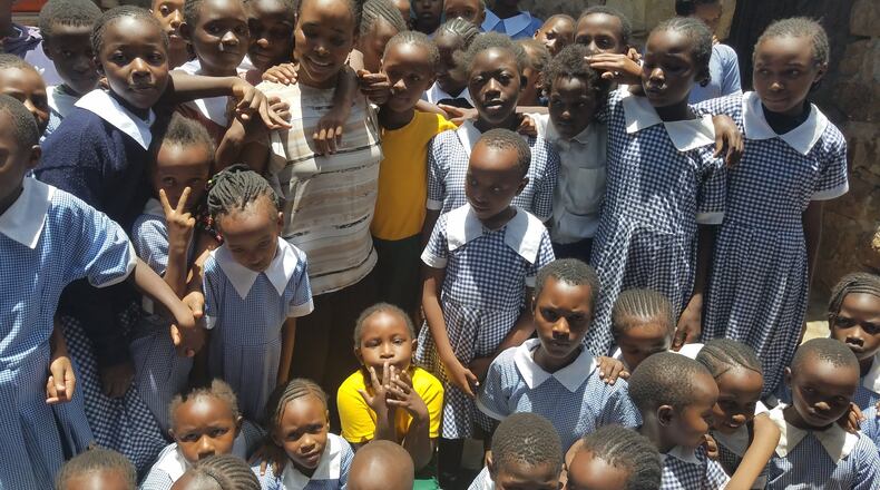 Grace Nkundabantu, a former refugee who fled the Democratic Republic of Congo, with some of the 120 orphans that she is funding through her foundation, the African Girls Hope Foundation. Photo courtesy of African Girls Hope Foundation