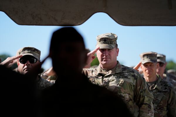 Members of the Army military salute during a ceremony at Fort Benning, honoring new namesake of World War I Fred Benning on Wednesday, April 16, 2025, in Fort Benning, Ga. (AP Photo/Brynn Anderson)