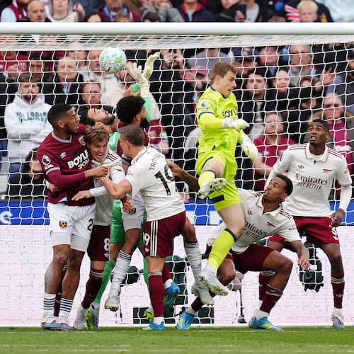 Arsenal goalkeeper David Raya, center, is fouled by West Ham United's Pablo Felipe in the build up to Callum Wilson disallowed goal during the English Premier League match in London, Sunday May 10, 2026. (John Walton/PA via AP)