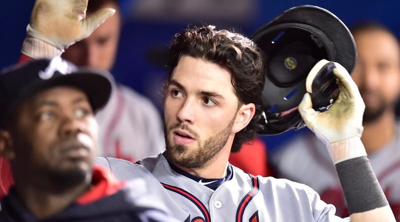 Braves shortstop Dansby Swanson is congratulated in the dugout after hitting a solo home run against the Toronto Blue Jays during the seventh inning. (Frank Gunn/The Canadian Press via AP)