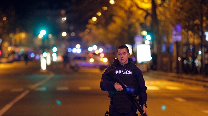 PARIS, FRANCE - NOVEMBER 13: A policeman patrols near the Boulevard des Filles-du-Calvaire after an attack November 13, 2015 in Paris, France. Gunfire and explosions in multiple locations erupted in the French capital with early casualty reports indicating at least 60 dead. (Photo by Thierry Chesnot/Getty Images)