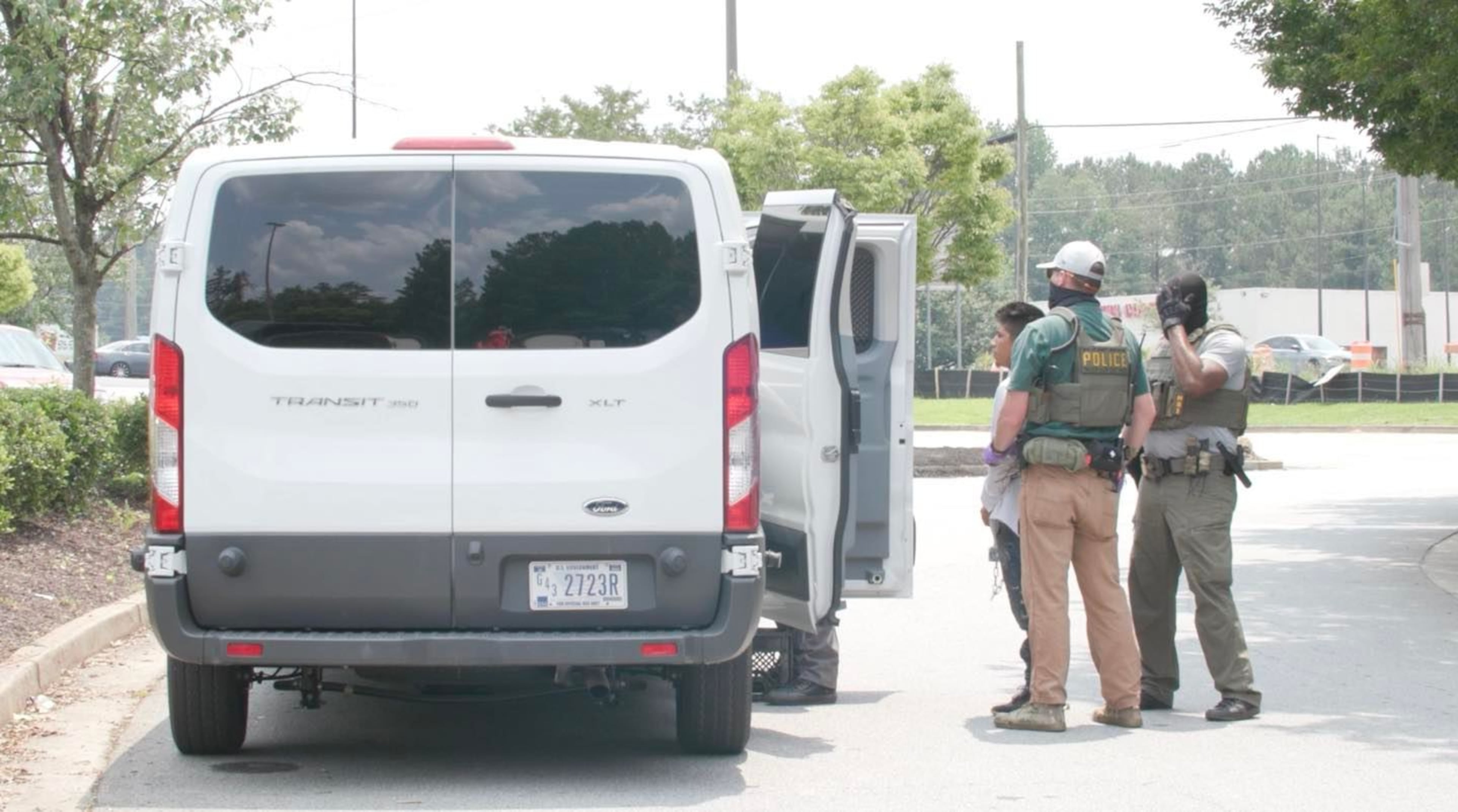 Federal agents arrest day laborers and load them into a white van outside a Home Depot in Riverdale. “We aren’t notified that immigration enforcement activities are going to happen, and we aren’t involved in the operations," says Beth Marlowe, a company spokesperson. (Courtesy of MGNews)