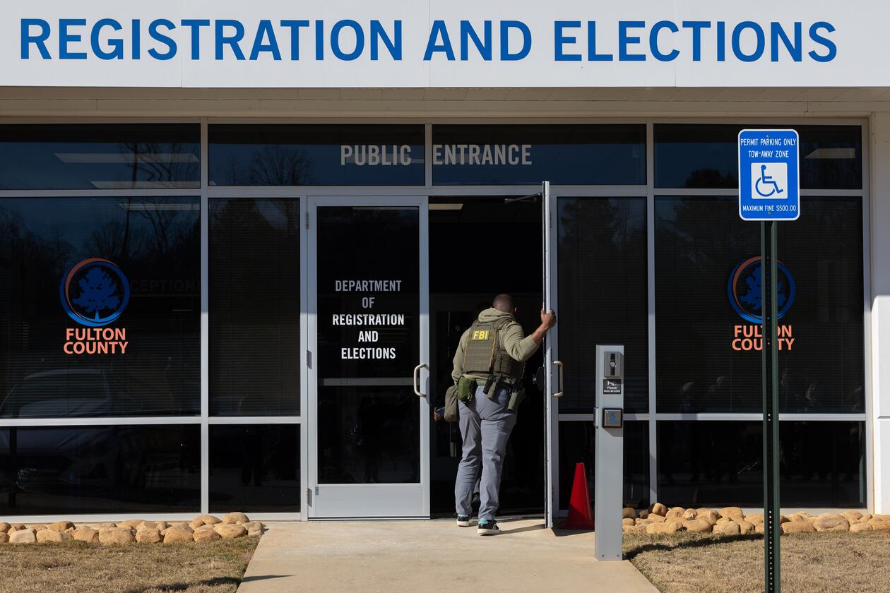 FBI agents enter the Fulton County Election Hub and Operation Center in Union City this past January. (Arvin Temkar/AJC)