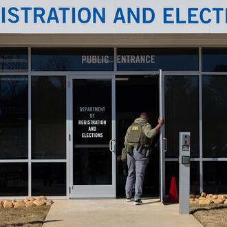 FBI agents enter the Fulton County Election Hub and Operation Center in Union City this past January. (Arvin Temkar/AJC)