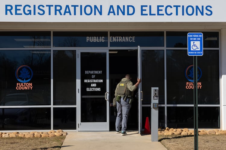 FBI agents enter the Fulton County Election Hub and Operation Center in Union City this past January. (Arvin Temkar/AJC)