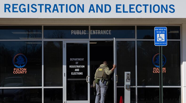 FBI agents enter the Fulton County Election Hub and Operation Center in Union City this past January. (Arvin Temkar/AJC)