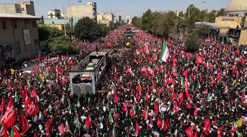 A truck carrying the coffins of the late Iranian Supreme Leader Ayatollah Ali Khamenei and members of his family makes its way through mourners during the funeral procession in Tehran, Iran, Monday, July 6, 2026. (AP Photo/Vahid Salemi)