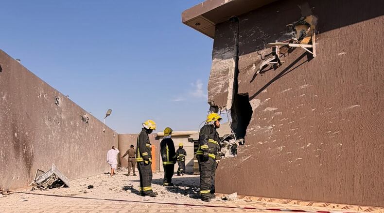 This photo provided by the Saudi Press Agency shows firefighters inspecting damage to a building caused by falling debris from a drone that Saudi authorities said was launched by Yemen's Houthi rebels and intercepted over Taif province, western Saudi Arabia, Thursday, Sept. 17, 2026. (Saudi Press Agency via AP)
