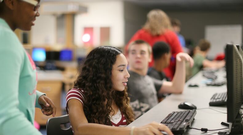 Students log in at the Flex lab to check on their coursework at Locust Grove Middle School in Henry County. BOB ANDRES / BANDRES@AJC.COM