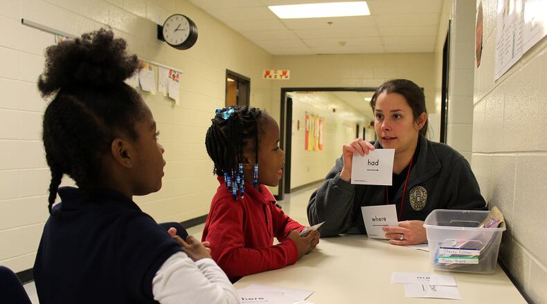 Covington city employee Kara Hipps works on reading skills with students at Middle Ridge Elementary. Hipps is part of a city-school partnership that has employees leading reading workshops for at-risk students. CONTRIBUTED