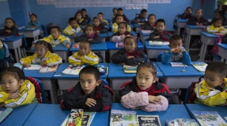Students at a Chinese primary school in western China sit at attention at their desks. (Adam Dean/The New York Times)
