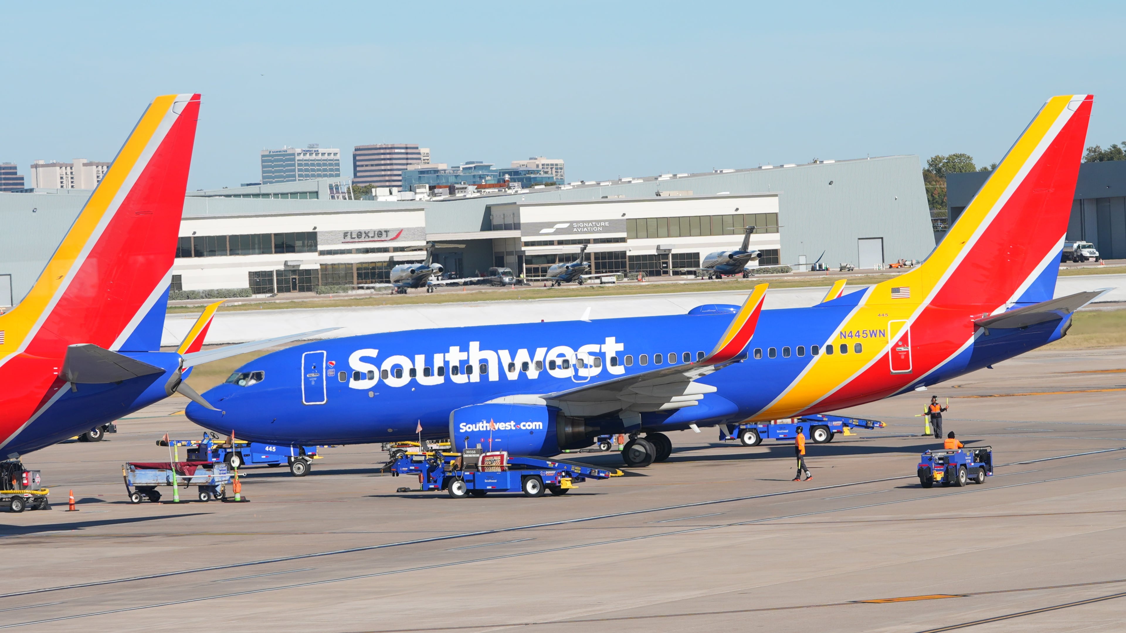 FILE - A Southwest Airlines jet pulls into a gate at Dallas Love Field Airport Tuesday, Nov. 11, 2025, in Dallas. (AP Photo/LM Otero, File)