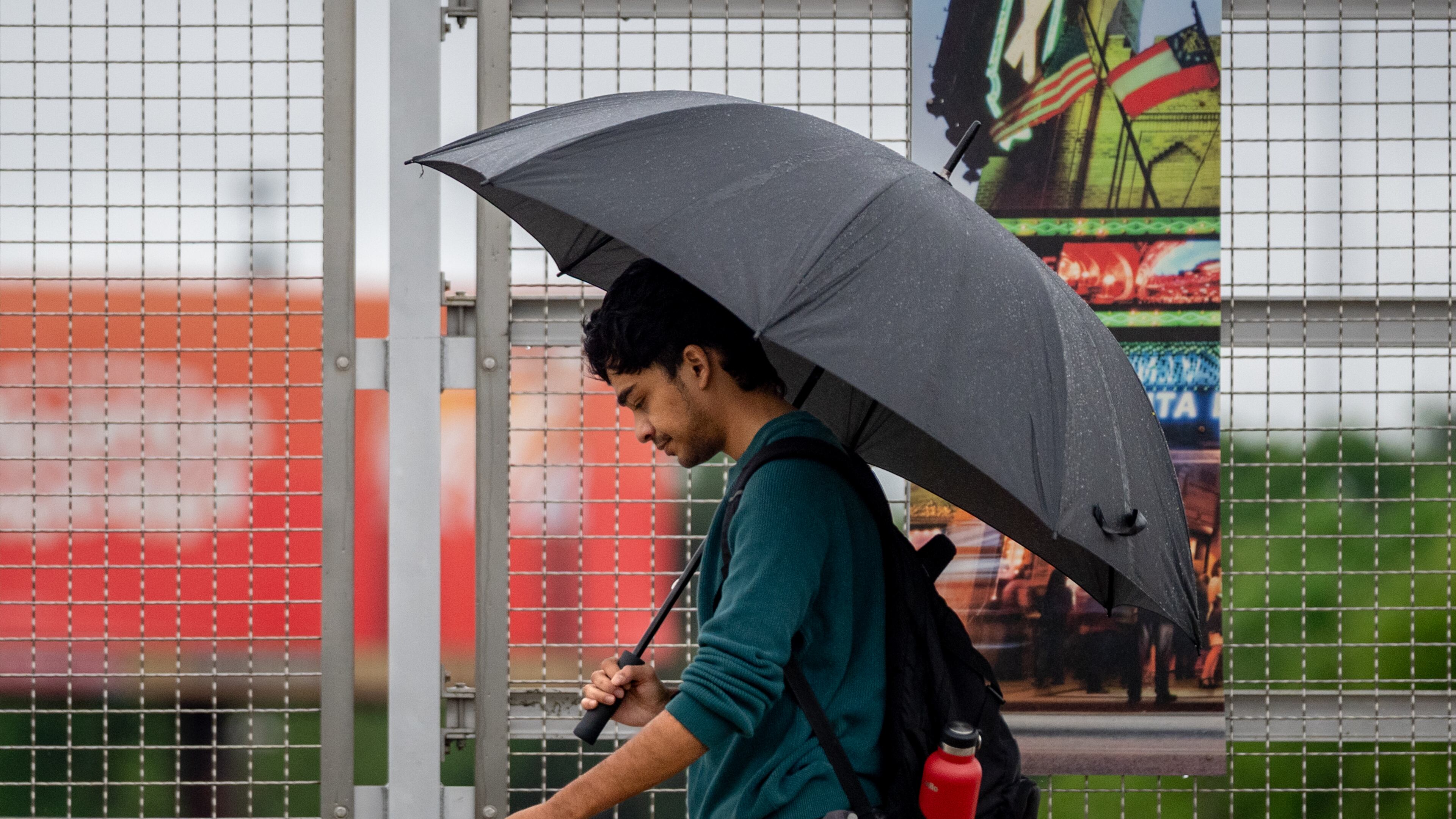 A man takes a rainy April walk along Peachtree Street in downtown Atlanta. The metro area has seen multiple inches of rain since the start of August. (Ben Hendren for the AJC)